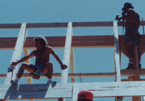 Todd Coash, president of 
NORTH STAR CONSTRUCTION & REMODELING CO. INC. CRC1330674, working on the roof decking of a log construction house. He was lead carpenter of this job of a crew of four. Circa. 1992