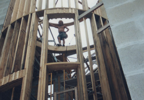 Todd Coash, president of 
NORTH STAR CONSTRUCTION & REMODELING CO. INC. CRC1330674, standing on top of custom engineered beam for a round spire structure at the entrance of a ten thousand square foot house that overlooks Tampa bay. Plans stated the structural beams for the spire were to be engineered in the field. He was lead carpenter in this photo. Circa. 2001