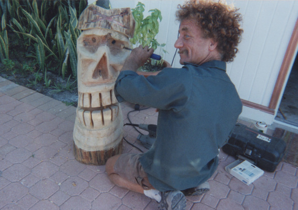 Todd Coash, president of 
NORTH STAR CONSTRUCTION & REMODELING CO. INC. CRC1330674, Carving one of his famous tikis. With copper inlay cross swords on the hat of the Pirate Tiki. Circa. 2008